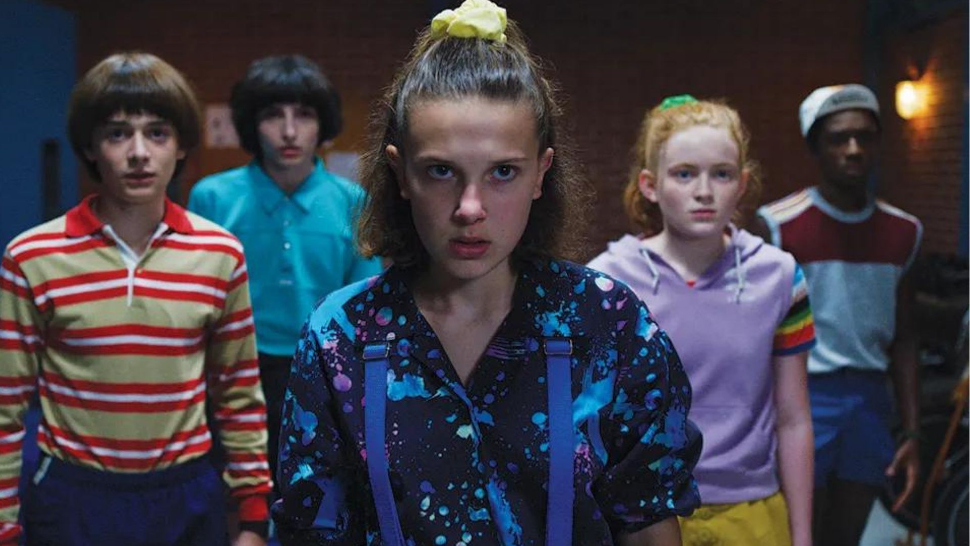 Eleven and her friends in Stranger Things (Image Source: Netflix)