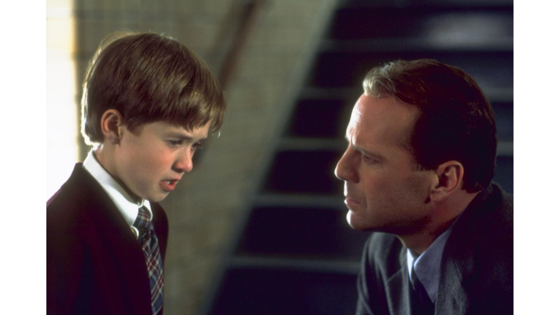 Bruce Willis as Dr. Malcolm Crowe &amp; Haley Joel Osment as Cole Sear (Image via Disney+, Hollywood Pictures)