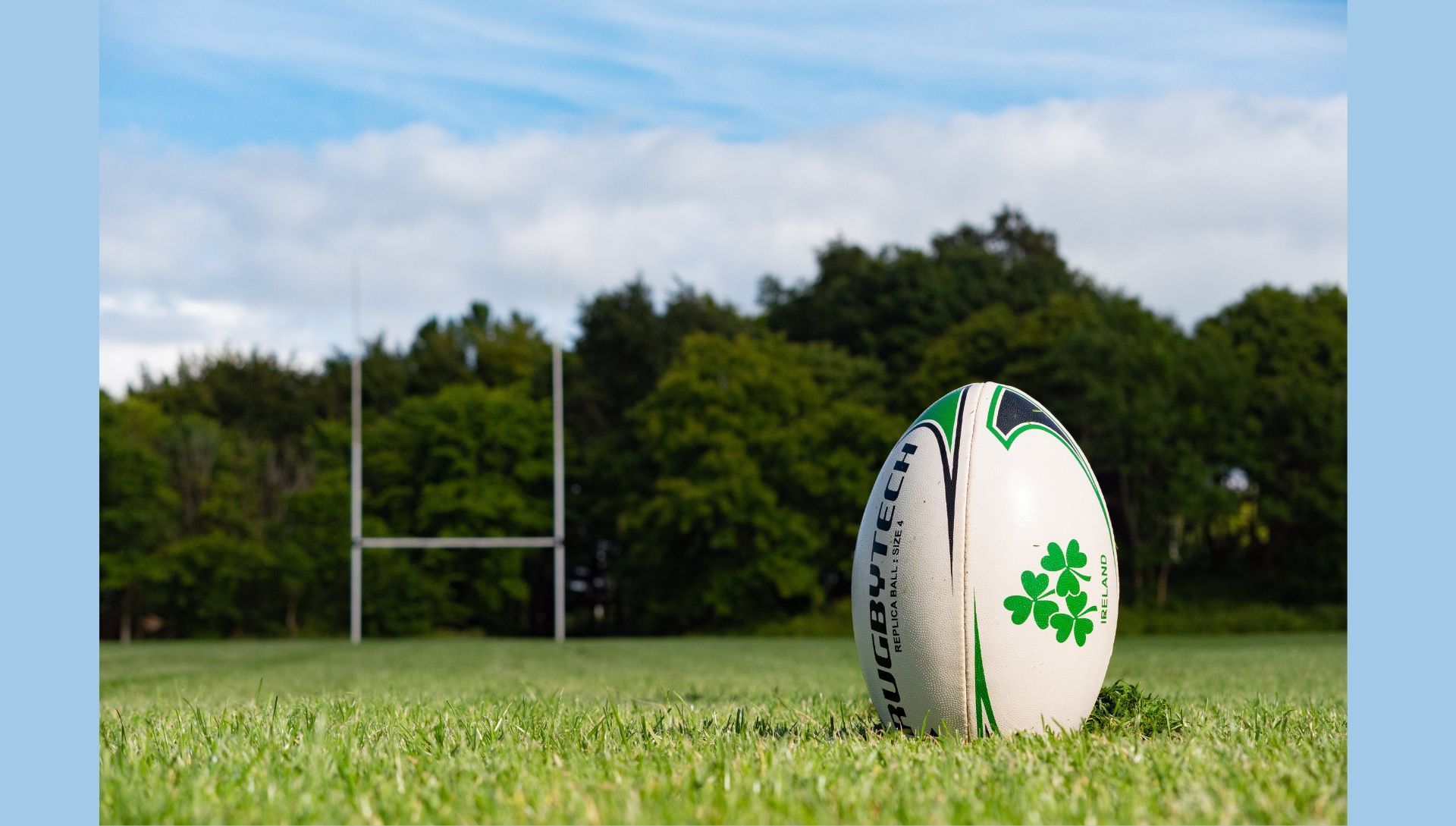 Rugby ball on grass pitch (Image via Pexels)