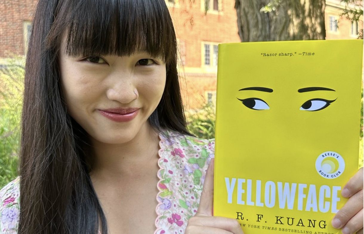 Author Rebecca Kuang poses with a copy of the book (Image via Instagram/@kuangrf)