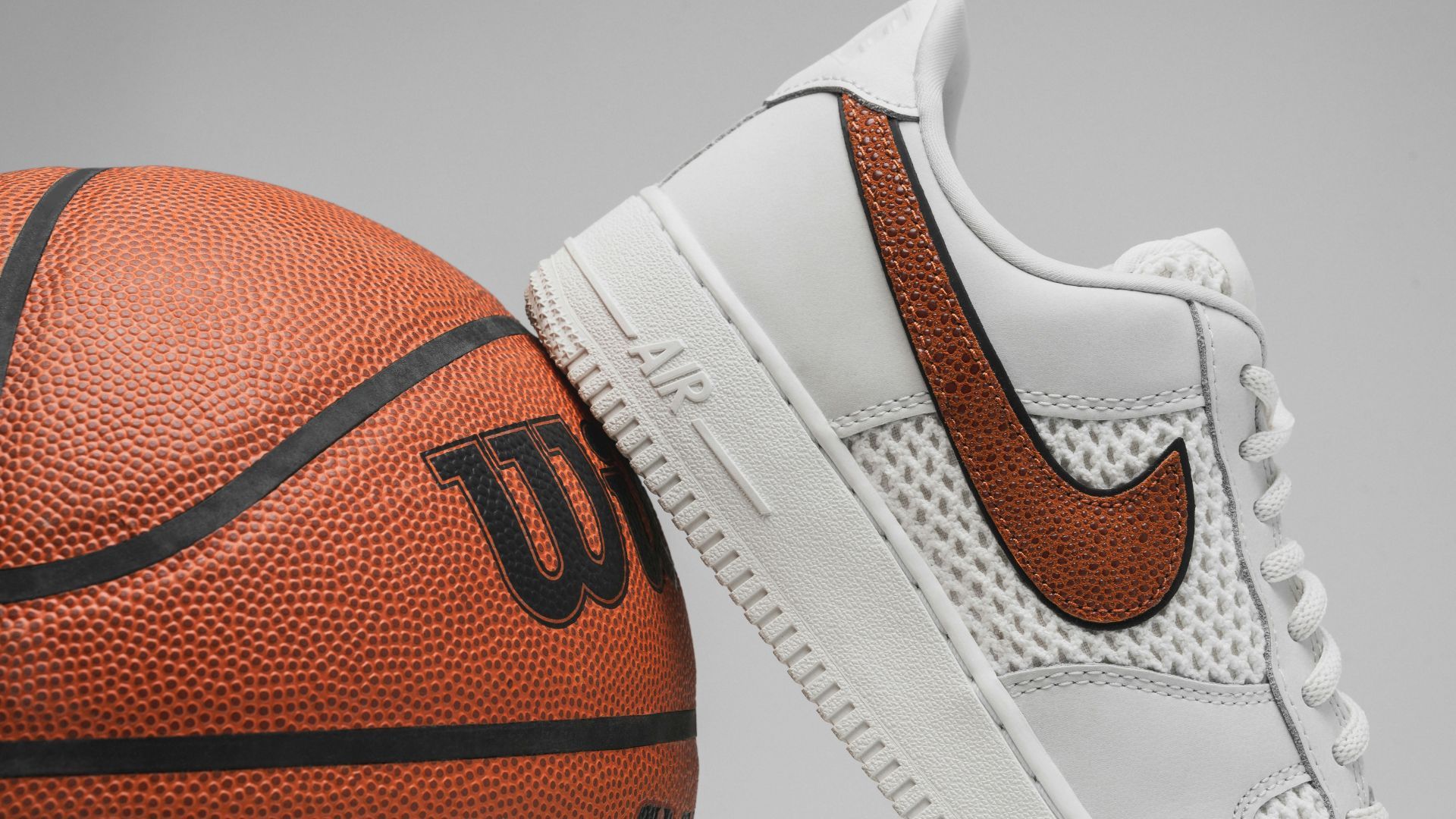 Nike Air sneakers on a basketball (Image via Unsplash / Karsten Winegeart)