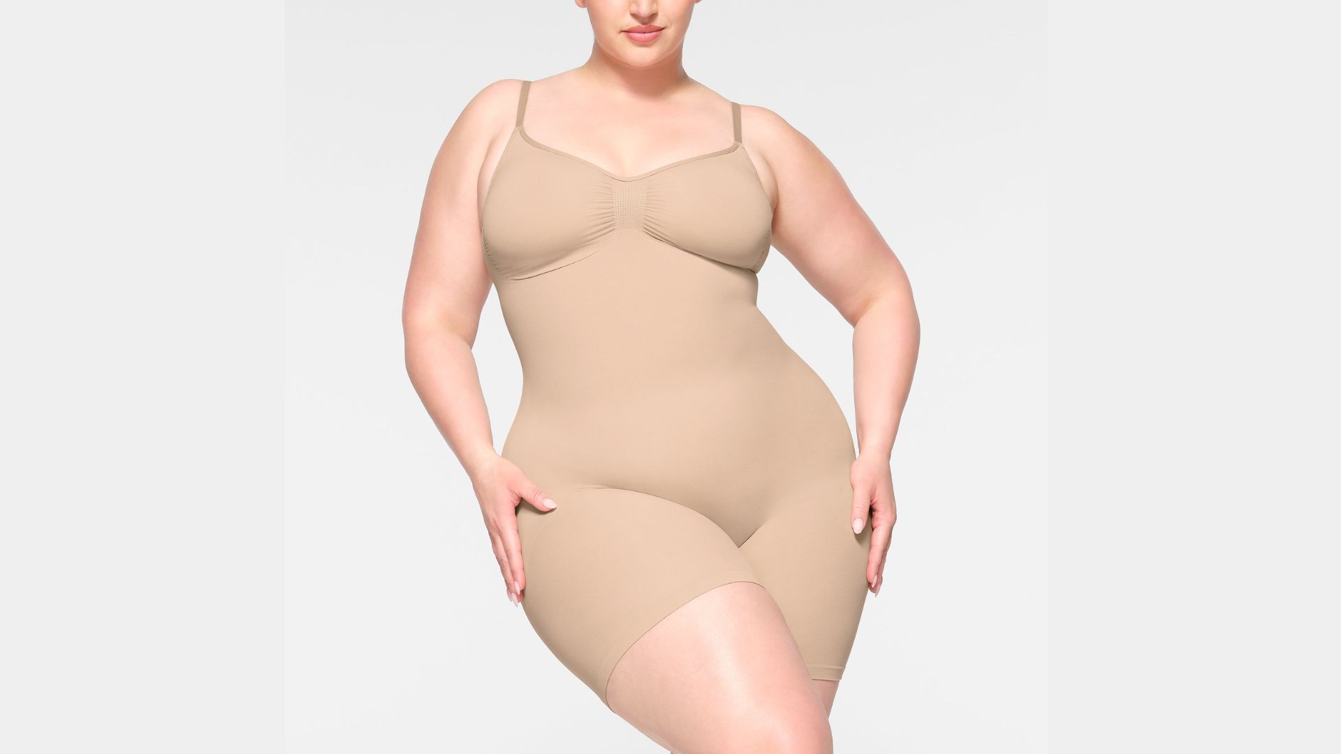 The Mid Thigh Bodysuit is the perfect shapewear for bodycon dresses (Image via Skims)