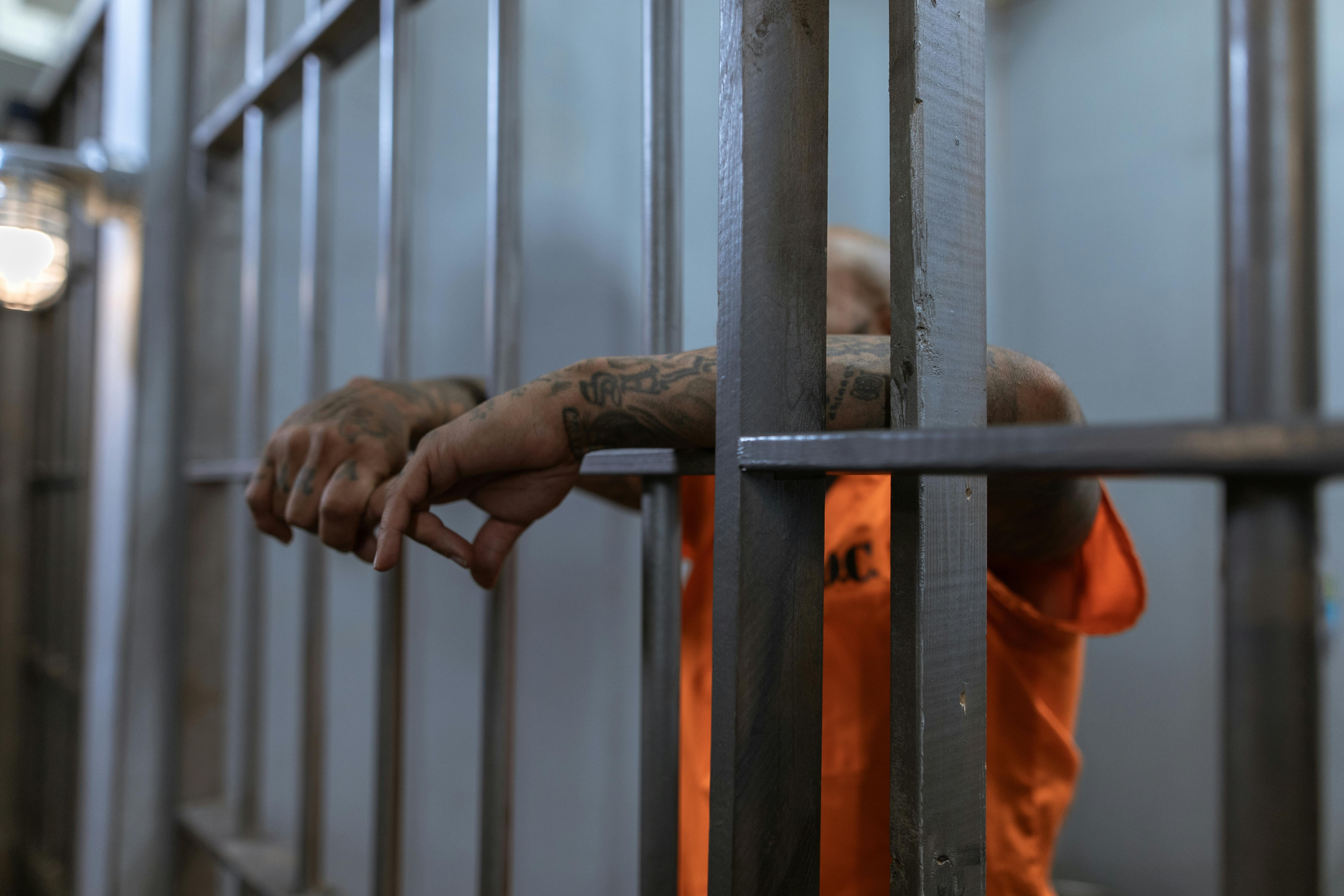 A Person in Orange Shirt with Tattooed Arms (image via RDNE Stock project/ Pexels)