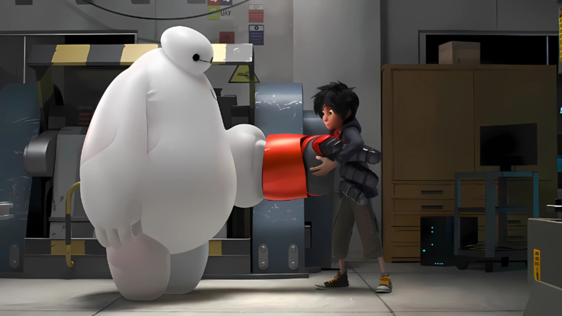 Hiro upgrades Baymax for their heroic mission in Big Hero 6 / Image Source: Disney UK