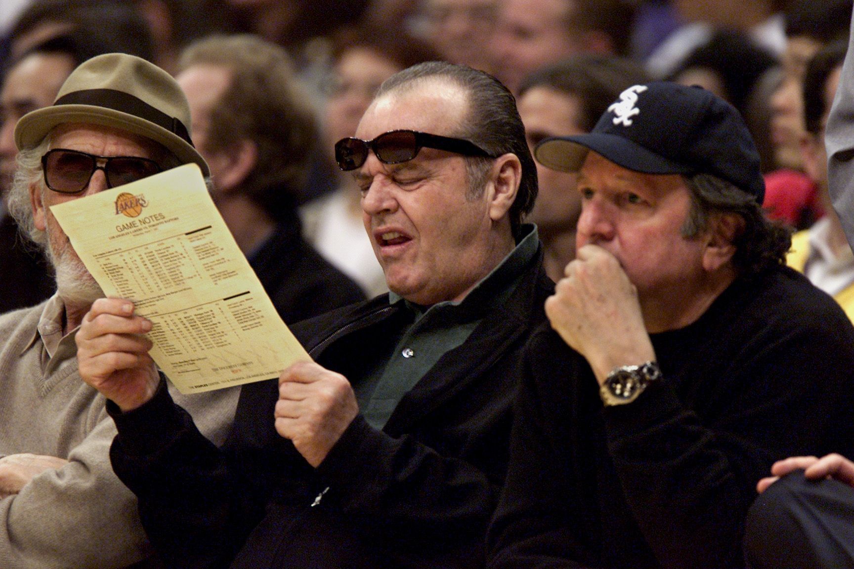 Jack Nicholson(center) looks over the Laker roster during a game against the Toronto Raptors at Staple - Source: Getty