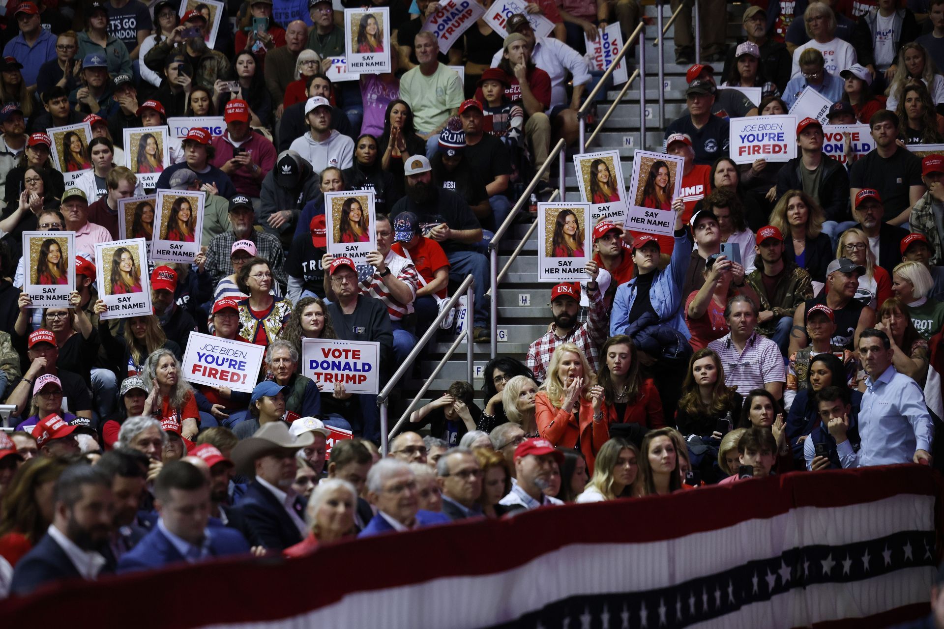 Donald Trump supporters hold Laken&#039;s posters during his campaign rally in Rome, GA (Image via Getty)