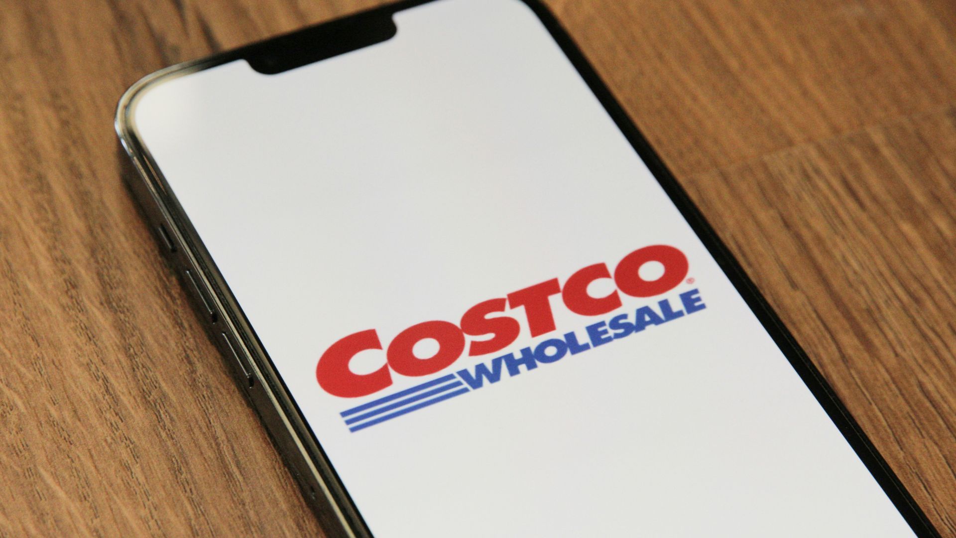 Costco Wholesale on the phone screen (Image via Unsplash / Marques Thomas)