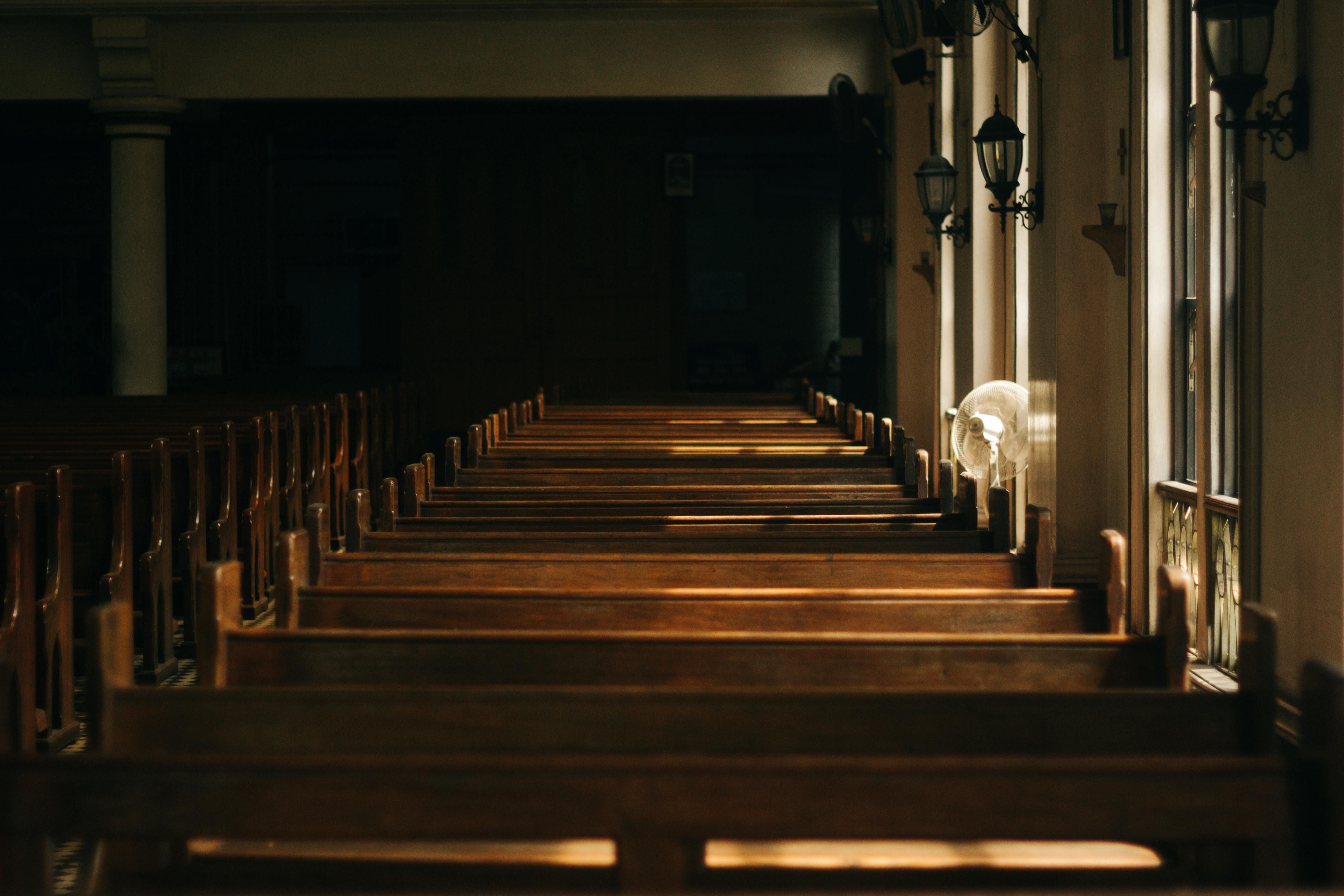 Brown Wooden Church Bench Near White Painted Wall (Image via Pexels)