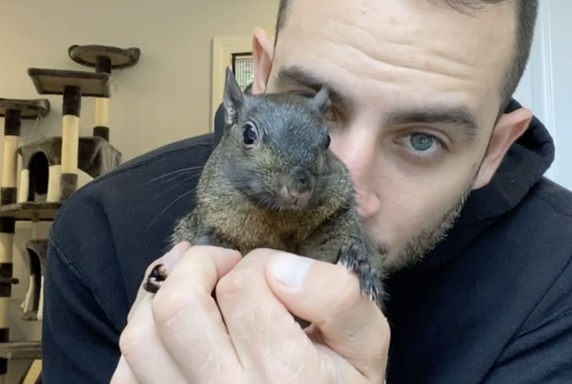 Mark Longo and the late Peanut the Squirrel (Image via Instagram/@squirrel_dad_12)