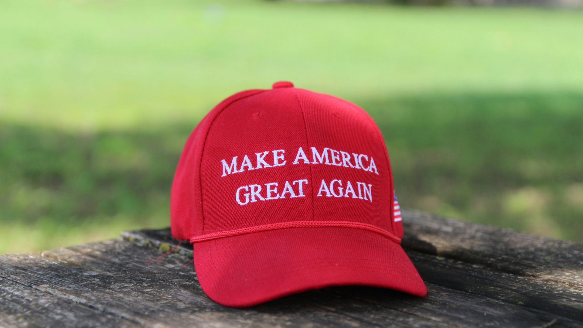 Trump Hat on wood (Image via Unsplash/Natilyn Photography)