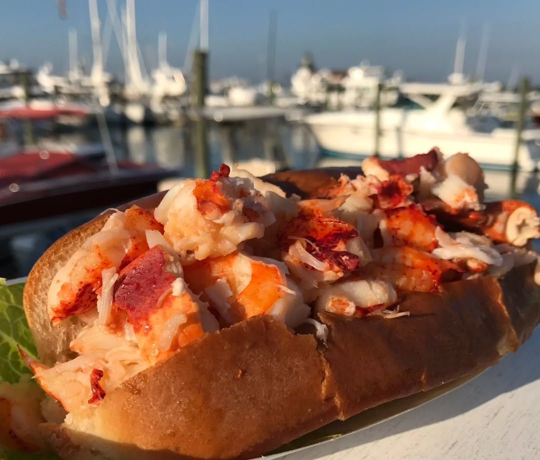 Lobster Roll with a sailboat view from Liv&#039;s Dockside Grill (Image via Instagram/@livsdocksidegrill)