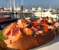 Lobster Roll with a sailboat view from Liv's Dockside Grill (Image via Instagram/@livsdocksidegrill)