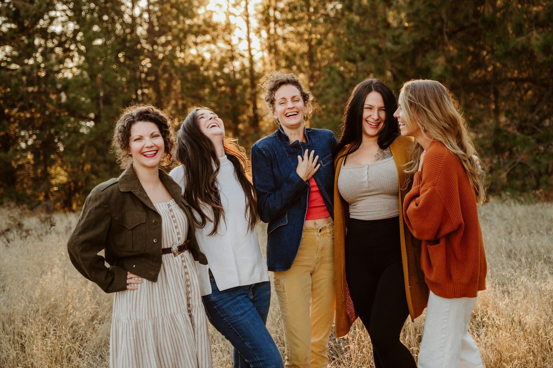 Women laughing together (Image via Unsplash/Amie Roussel)