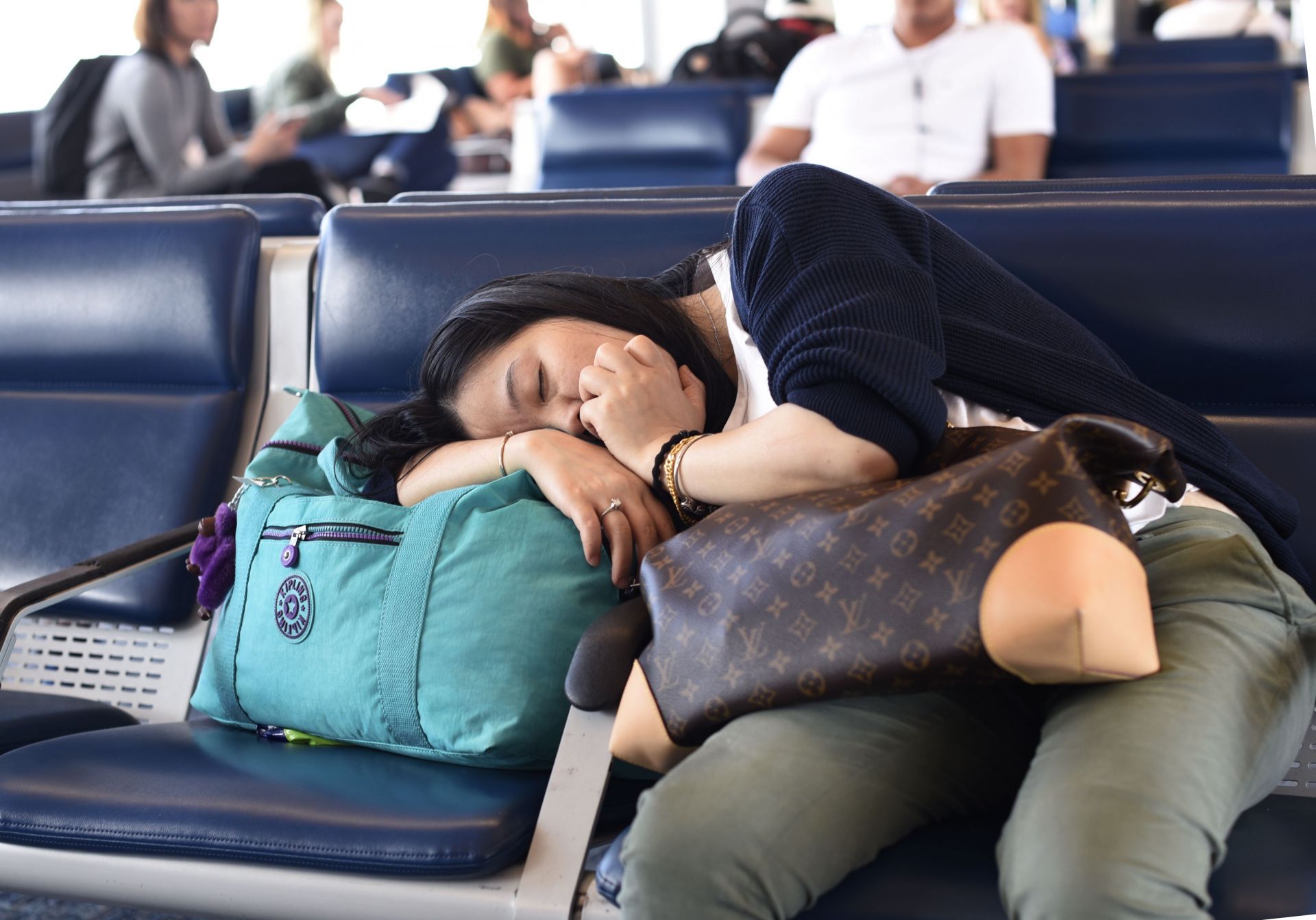 Air passenger sleeps at Denver International Airport. - Source: Getty