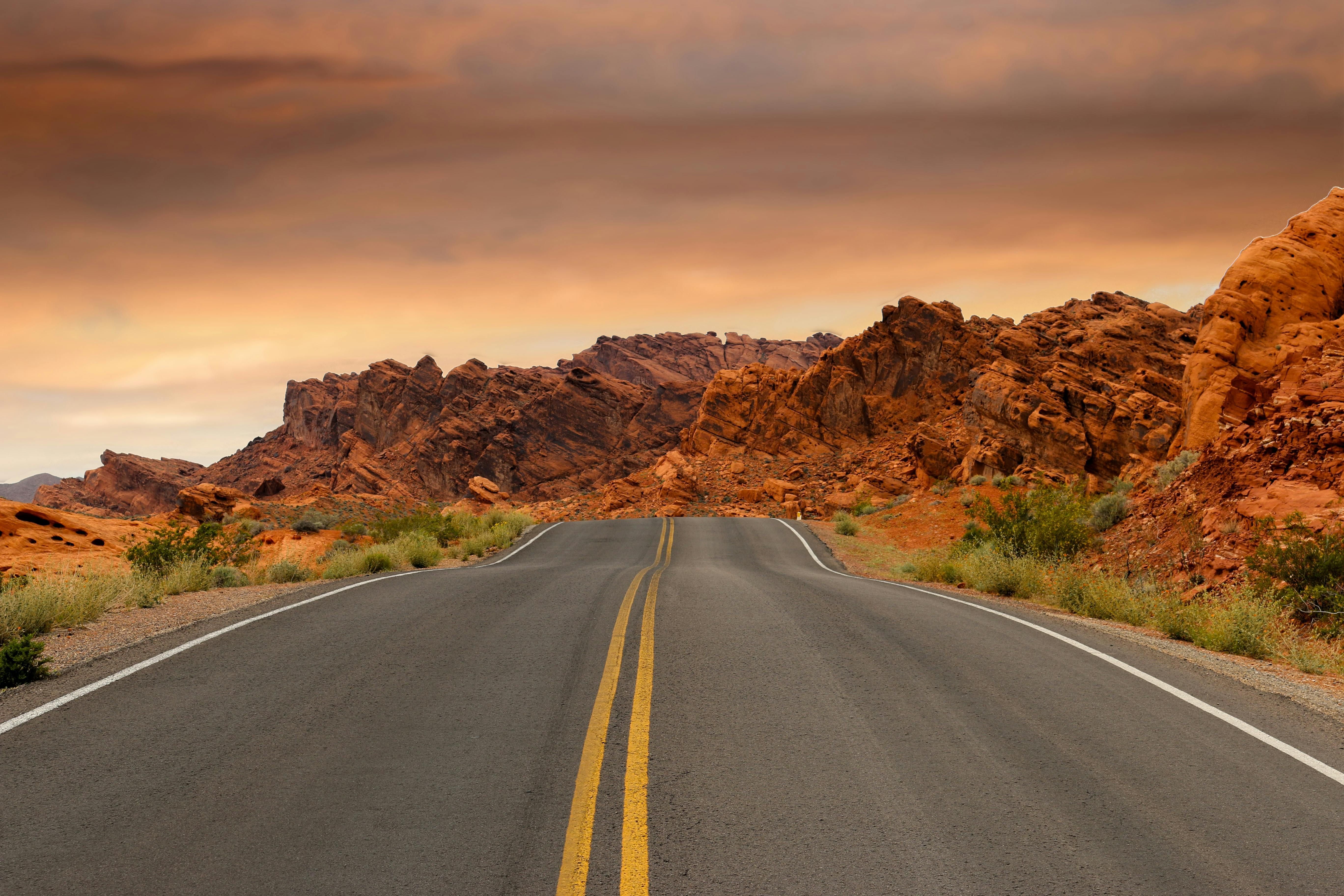 Gray Concrete Road Beside Brown Mountain during Golden Hour (Image via Pexels)