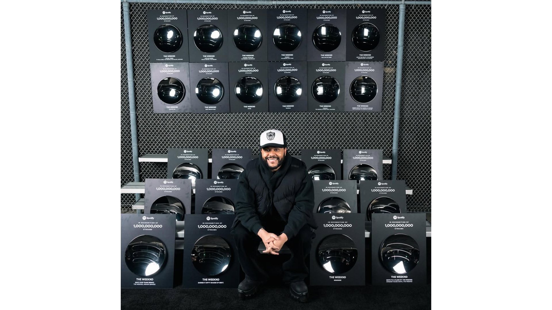 The Weeknd posing with Spotify Billion Club plaques (Image via Instagram/Spotify)