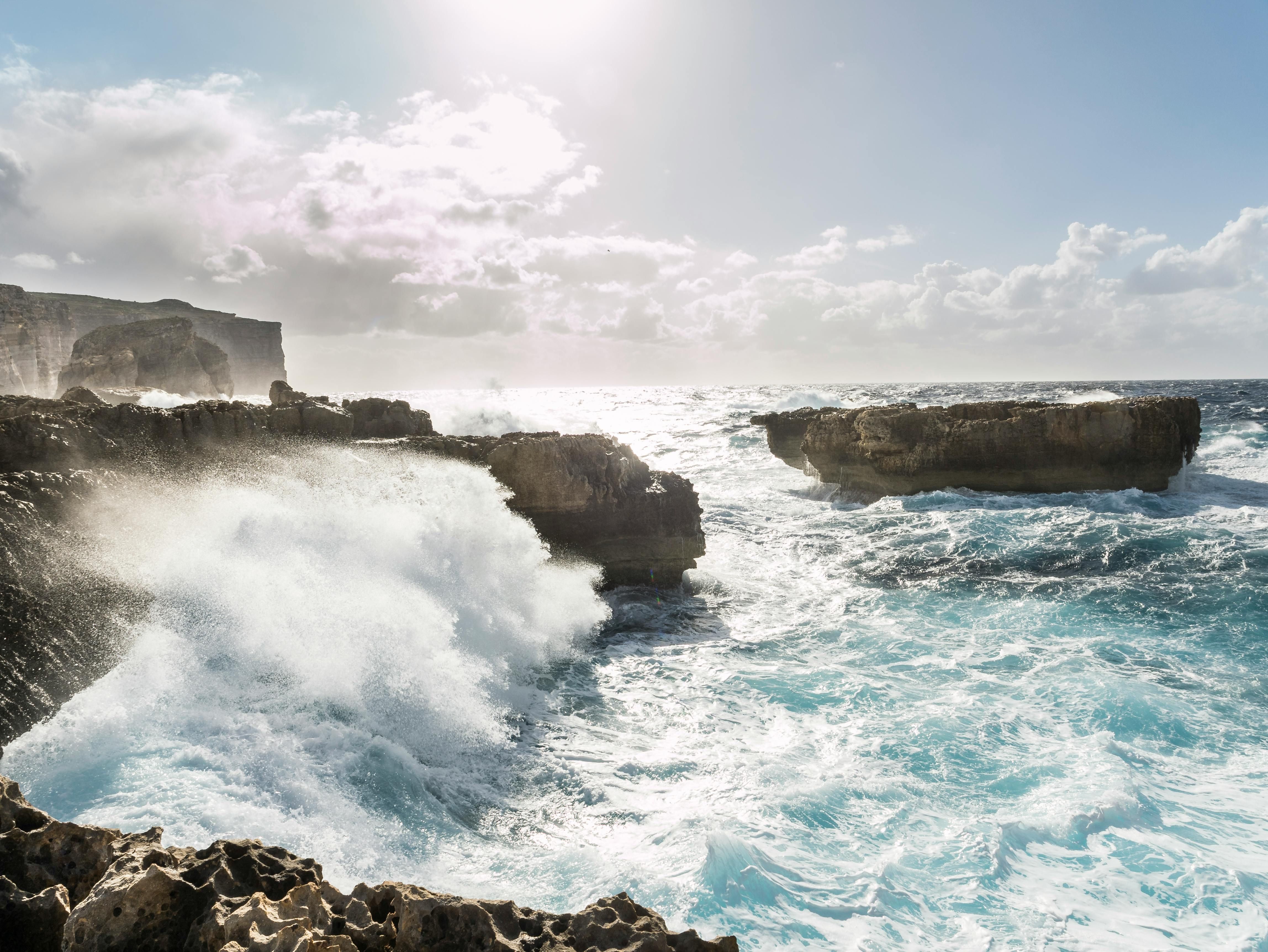 Brown Rock Formations Surrounded by Body of Water (Image via Pexels)