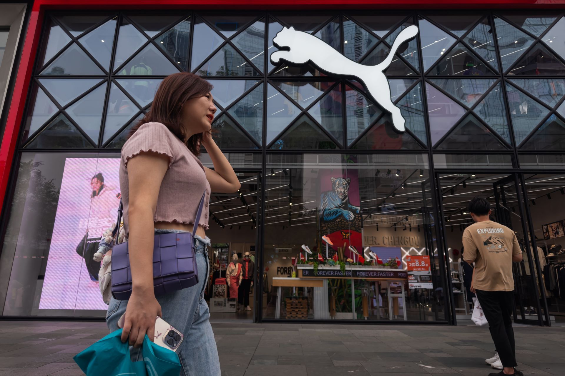 Pedestrian Outside PUMA Store in Chengdu - Source: Getty