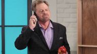 General Hospital's Scotty on the phone holding an apple. | Image Source: ABC