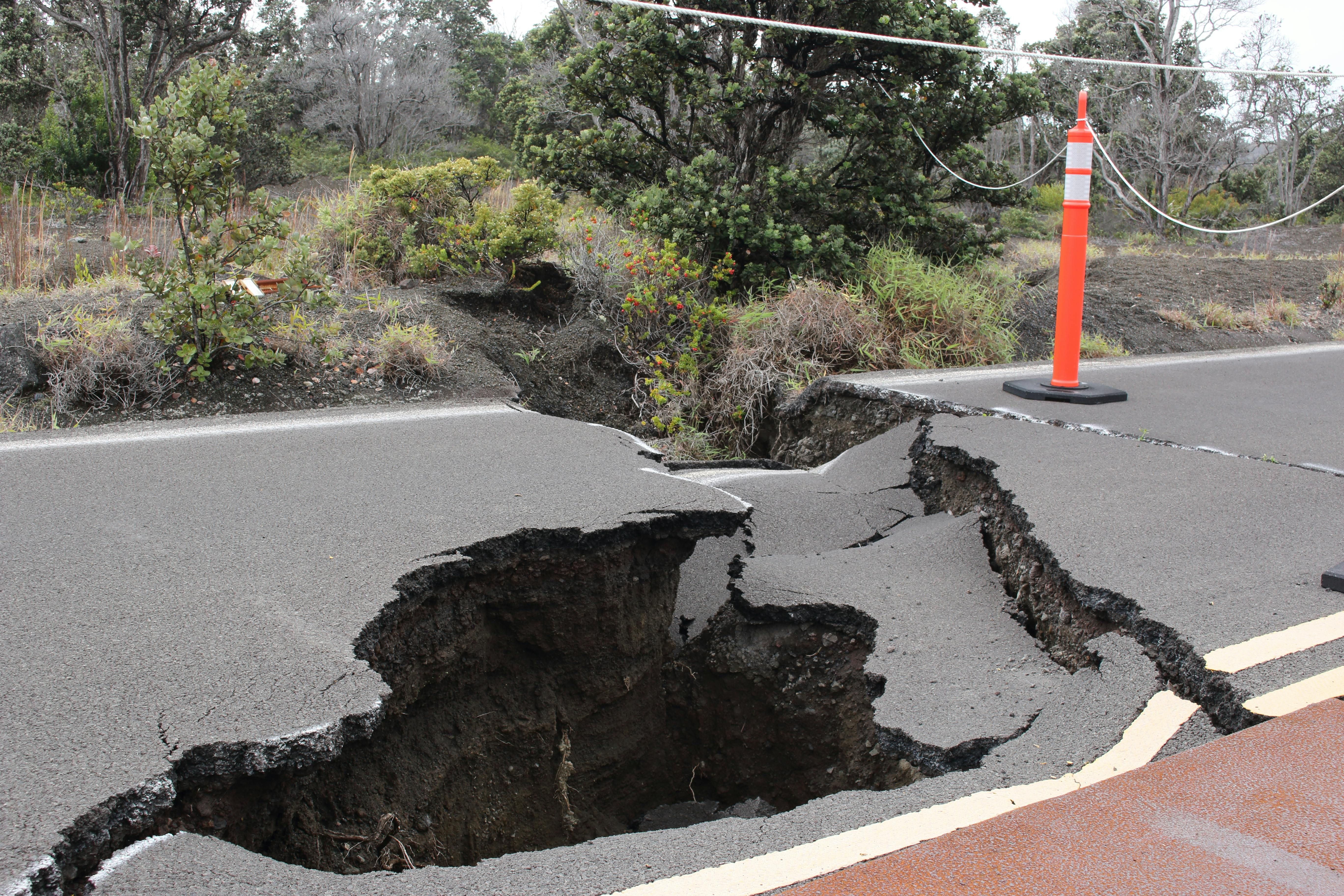 Orange and White Traffic Pole on Cracked Gray Asphalt Road (Image via Pexels)