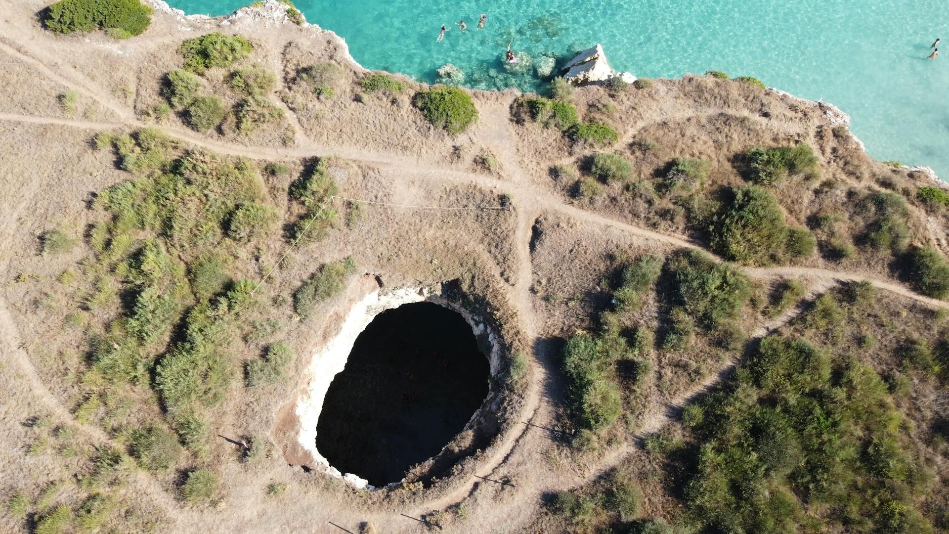 A sinkhole is a large hole that appears when a surface collapses or sinks