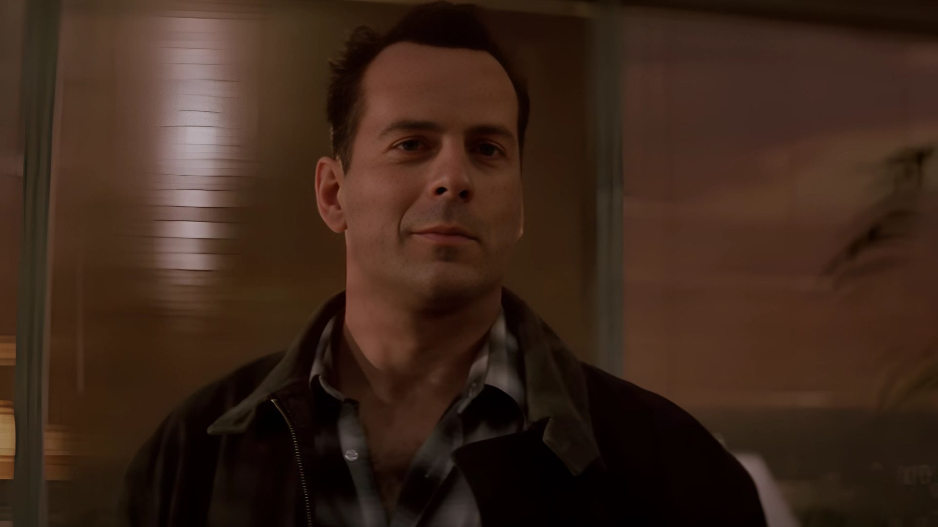 John McClane is seen smiling in Die Hard