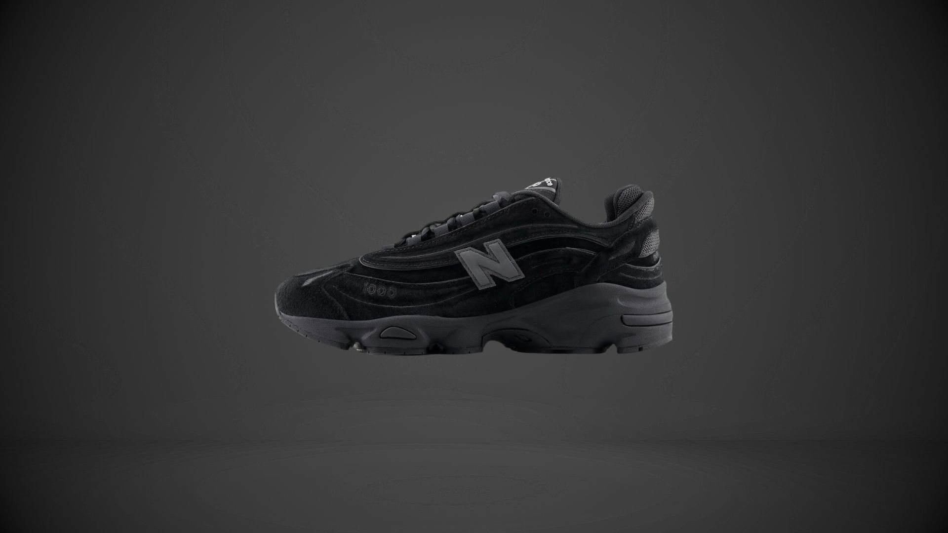 The lacing system features flat black laces threaded through reinforced eyelets for a secure fit (Image via New Balance)