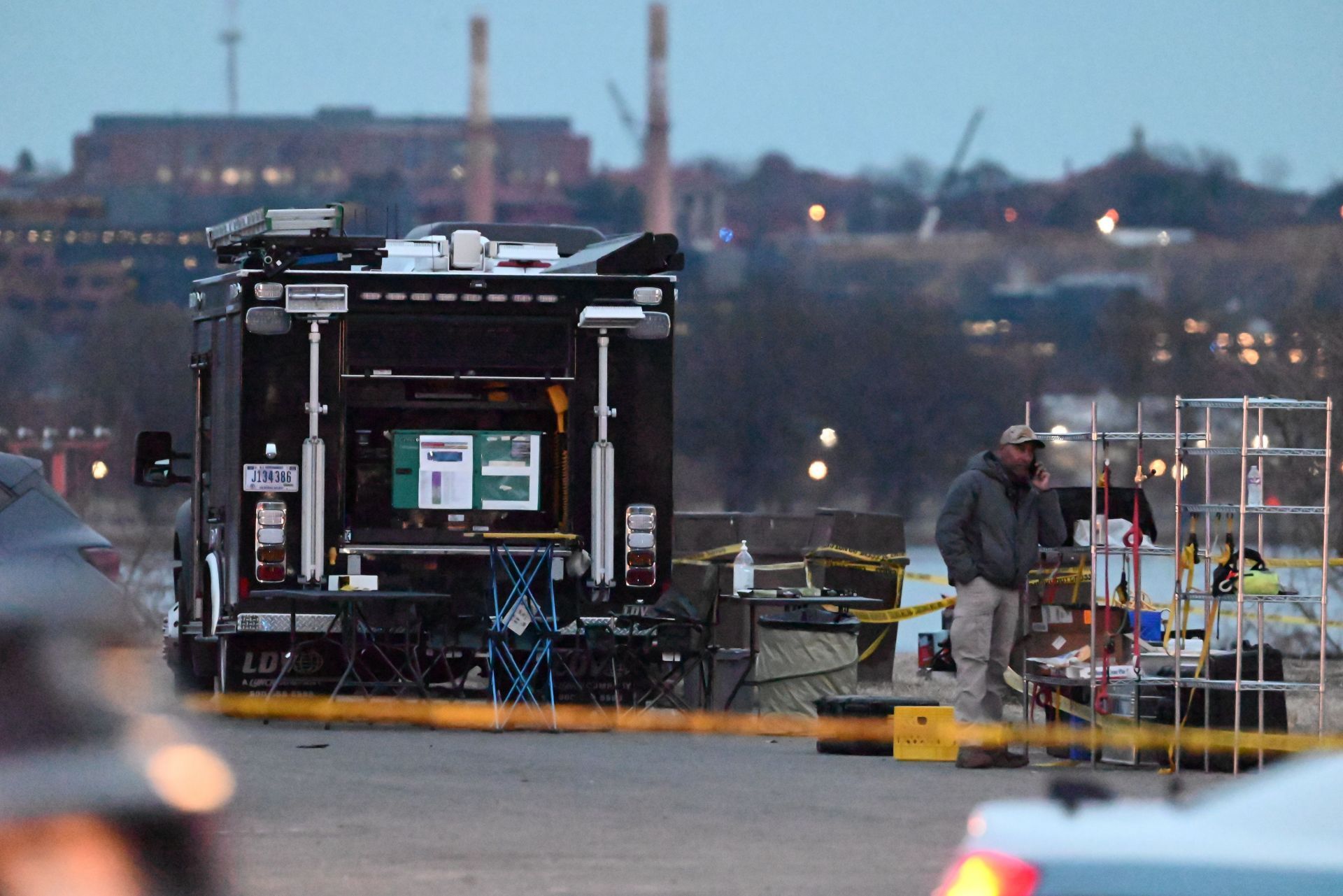 Local, state and federal law enforcement staging and collecting evidence at the crash site (Image via Getty)