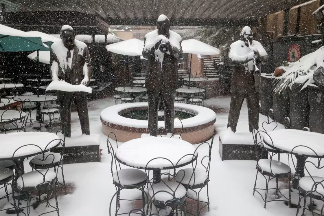 Snow-clad statues inside the New Orleans Musical Legends Park (image via Getty)