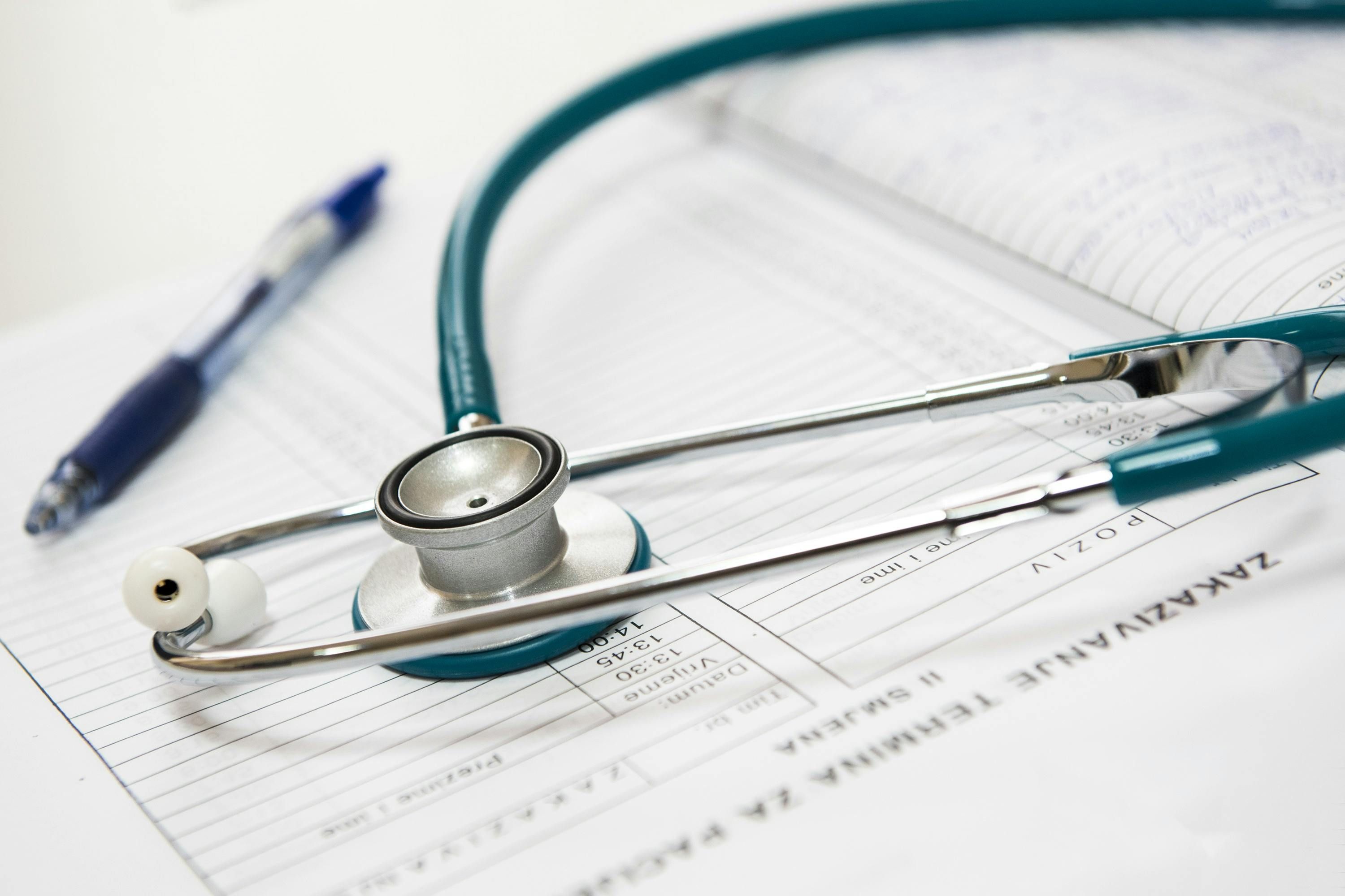 Tools of the trade: Medical documents, stethoscope, and pen. (https://www.pexels.com/photo/close-up-photo-of-a-stethoscope-40568/)