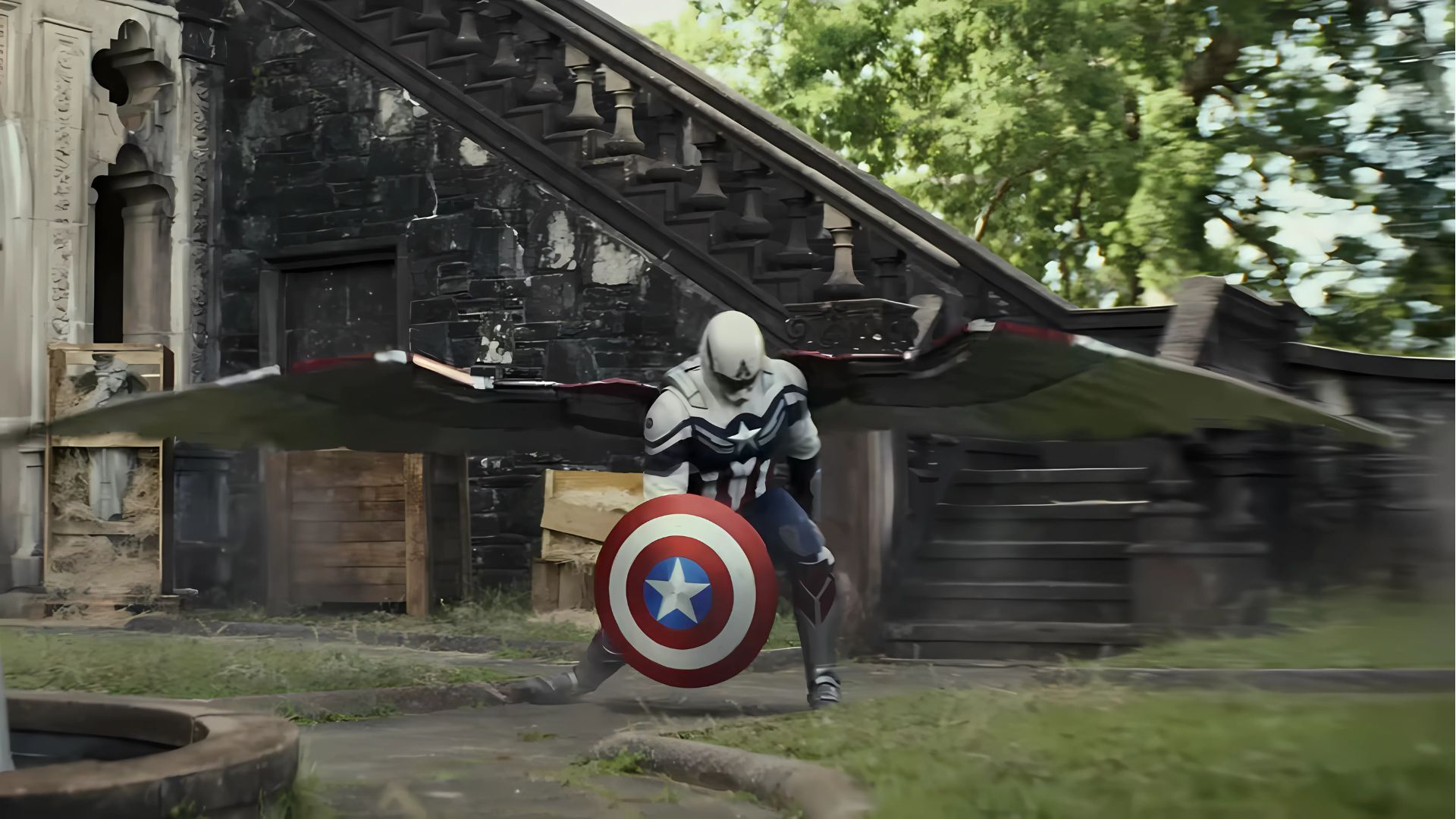 Captain America lands on the ground with his shield