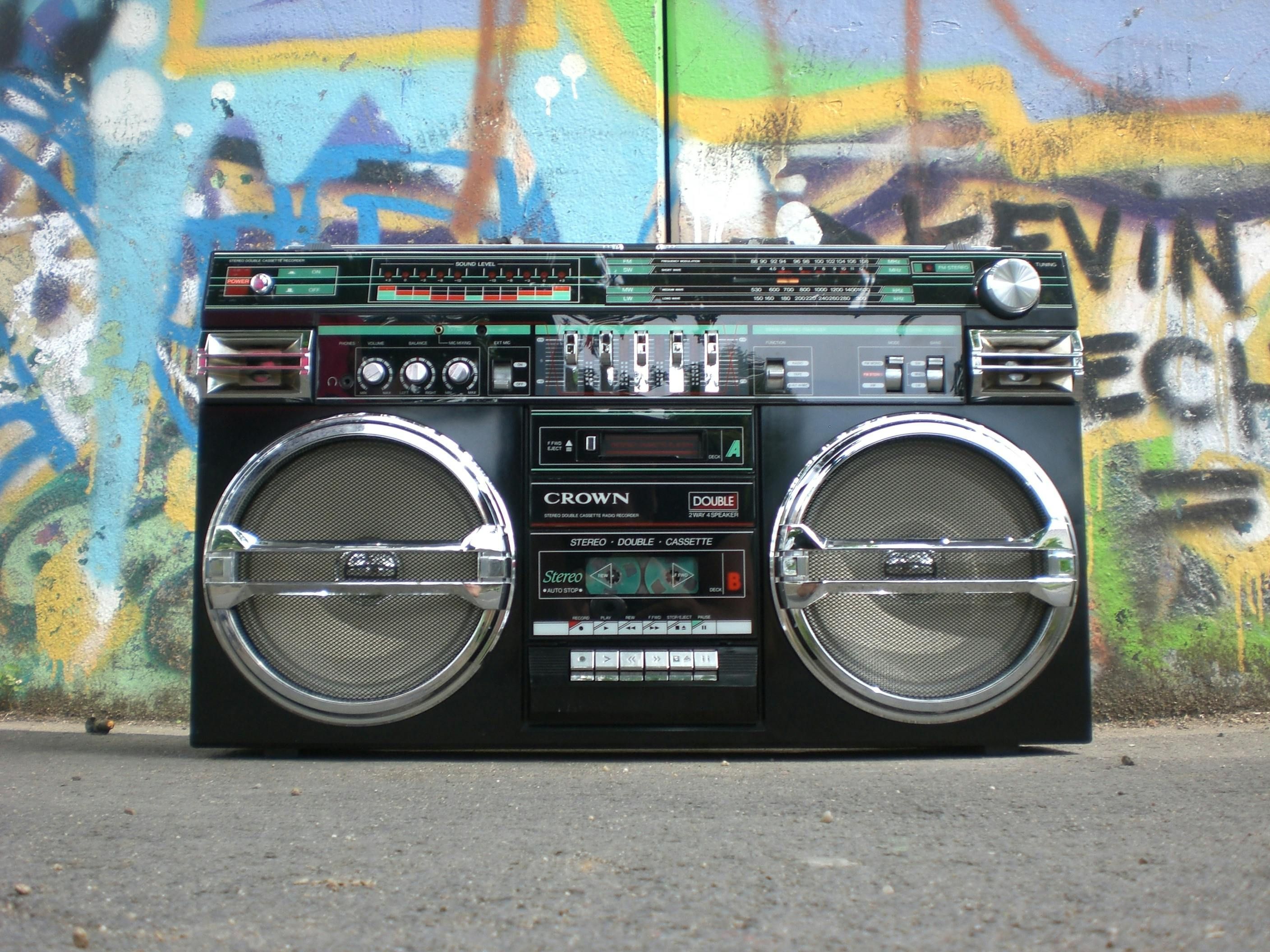 Urban Street Culture: A vintage boombox set against vibrant graffiti. (Image via Pexels) (https://www.pexels.com/photo/groud-level-shot-of-ghettoblaster-159613/)