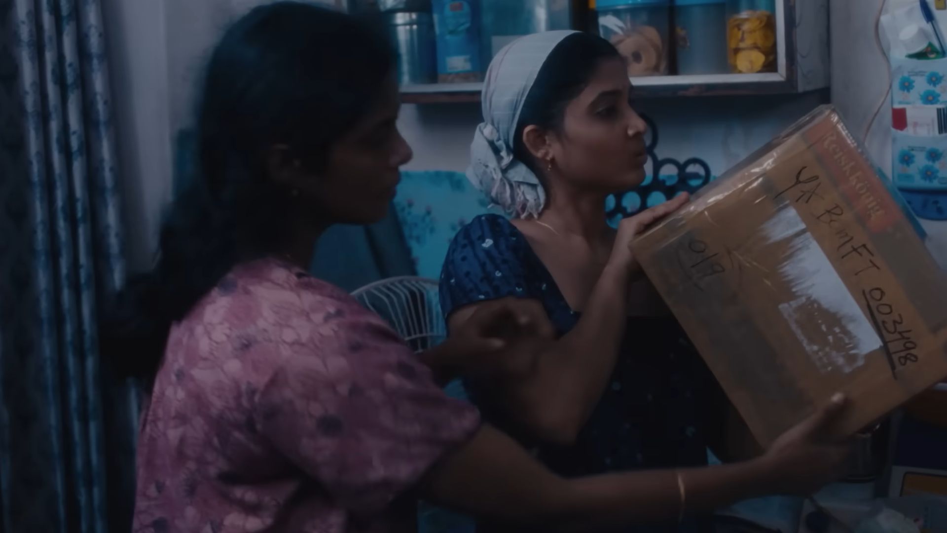 Two women checking a parcel