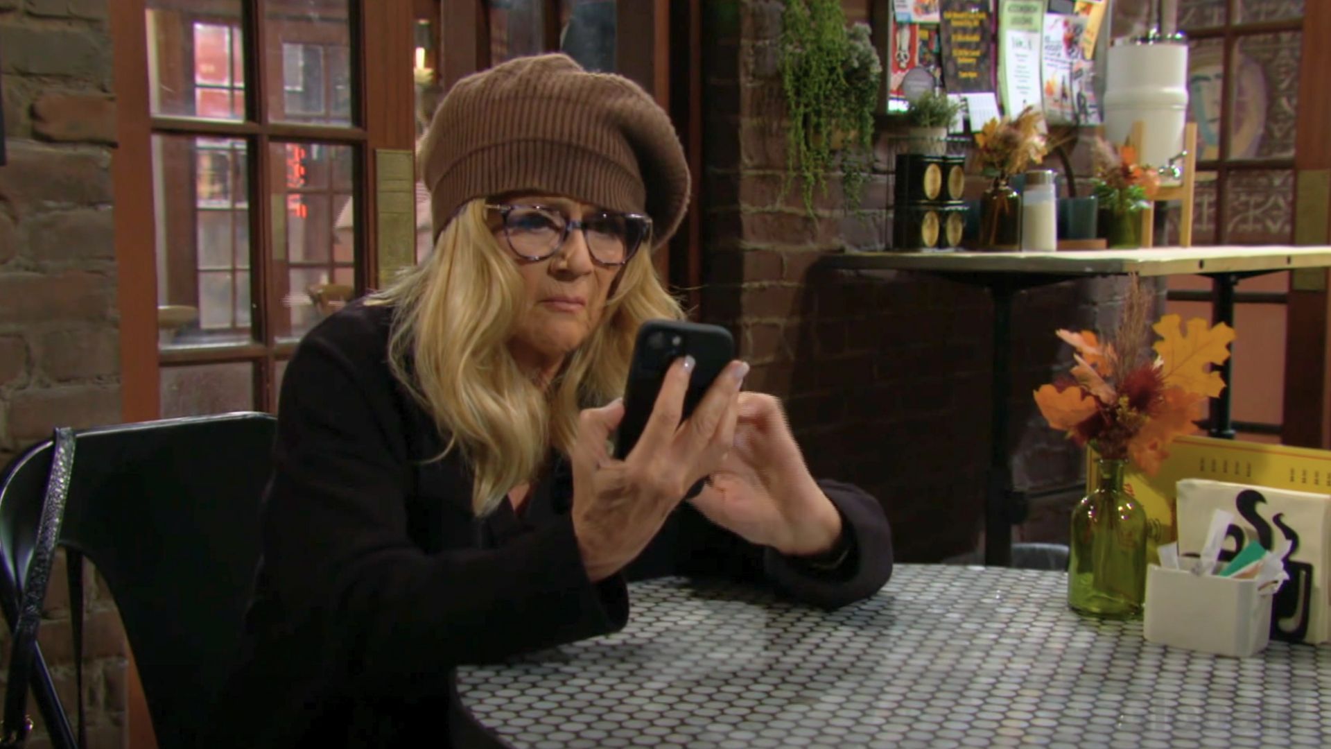 Jordan checks her phone on The Young and the Restless | Image: CBS