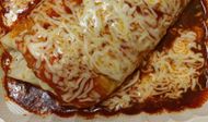 Wet burrito topped with cheese from Tacos Por Favor. (Image via Instagram/@tacosporfavor_inc)