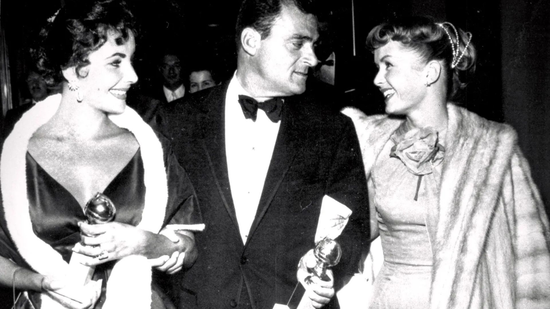 Elizabeth Taylor (left) with Mike Todd (middle) and Debbie Reynolds (right) (Image via Golden Globes)