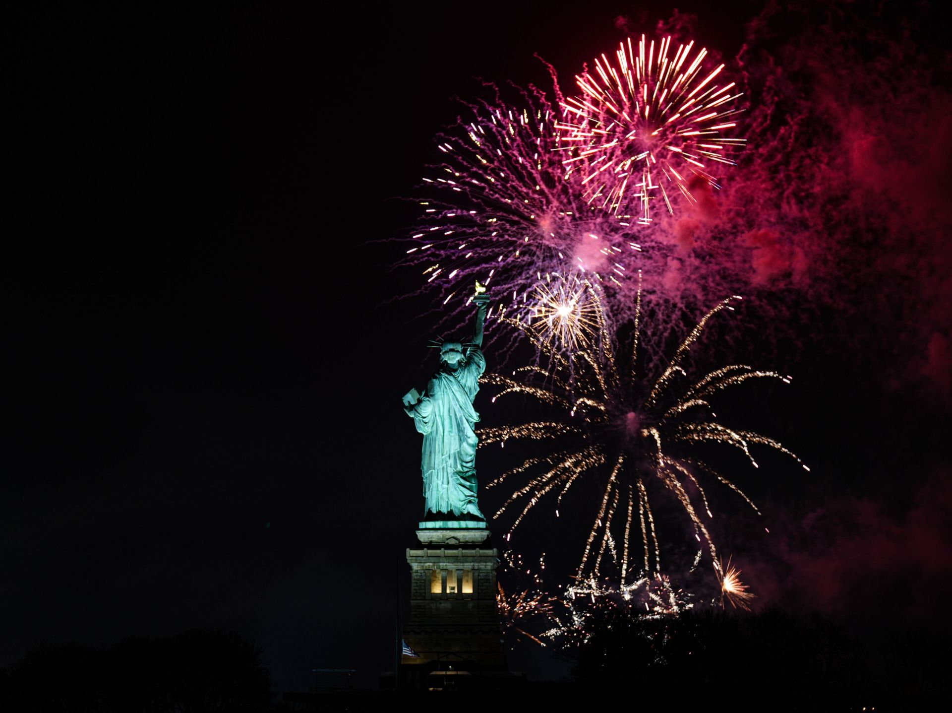 Fireworks light up sky over Statue of Liberty during New Year celebrations - Source: Getty