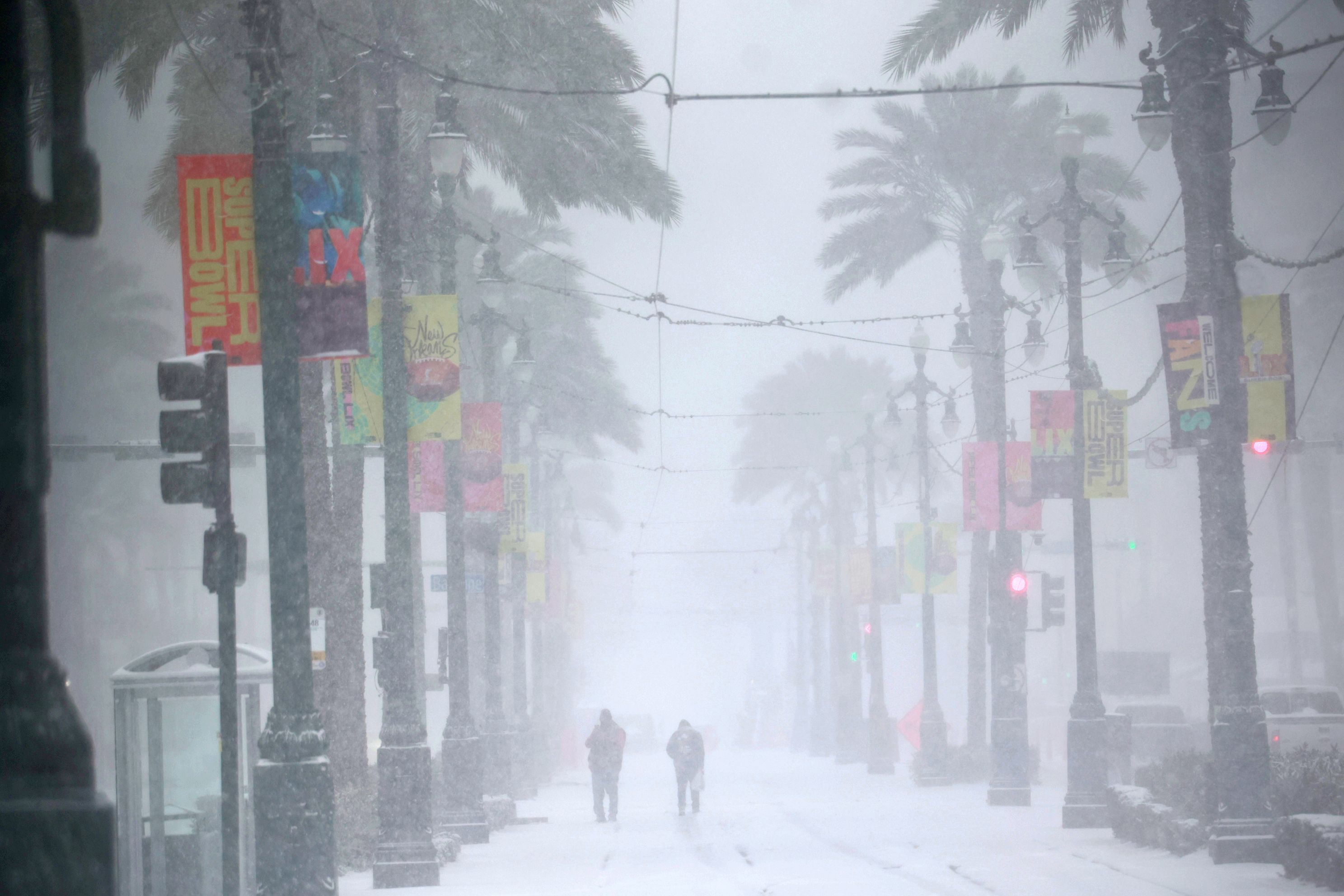 Commuters make their way down a snowy Canal Street on Tuesday (Image via Getty)