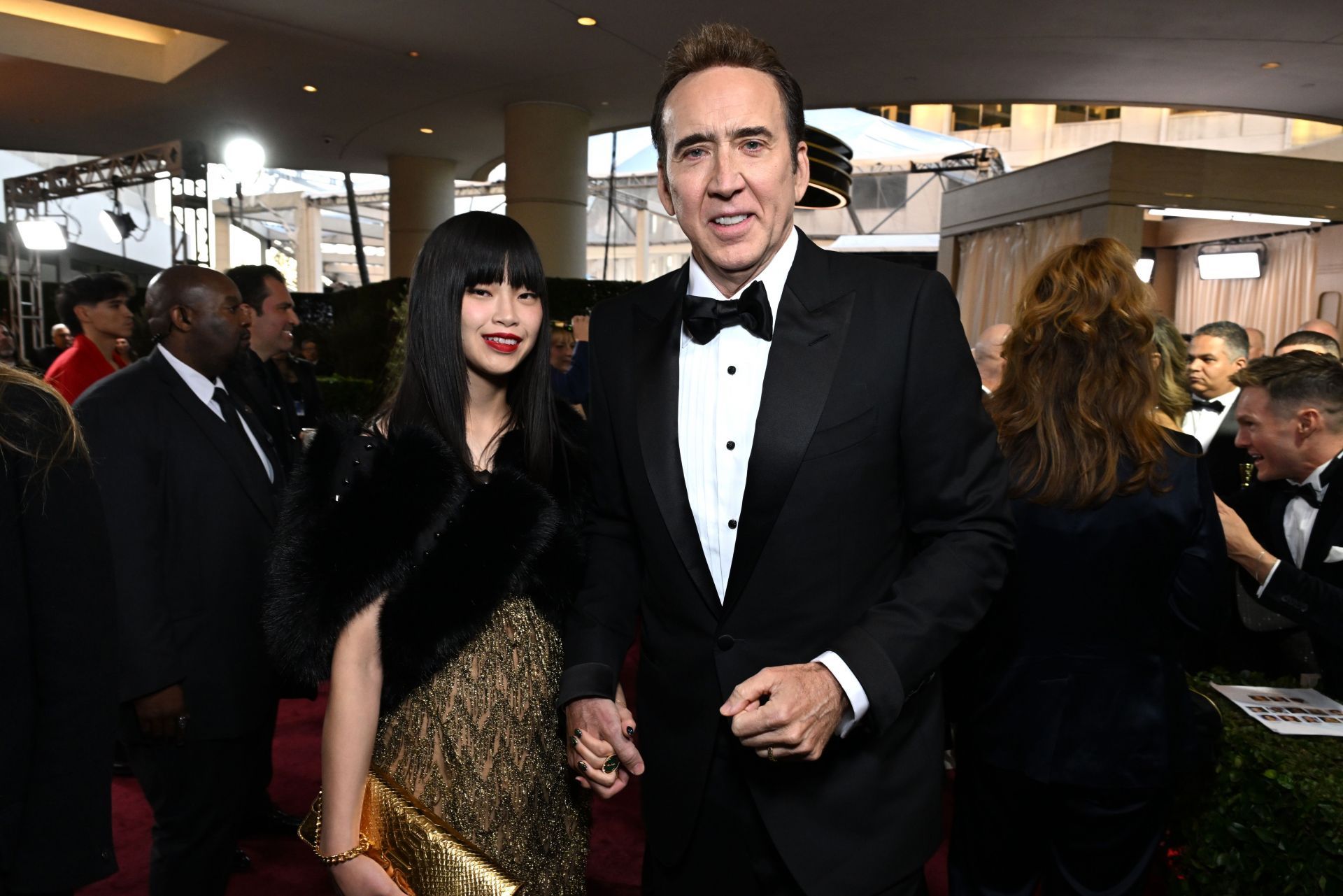 Nicolas Cage and Riko Shibata at the 82nd Annual Golden Globe Awards (Image via Getty)