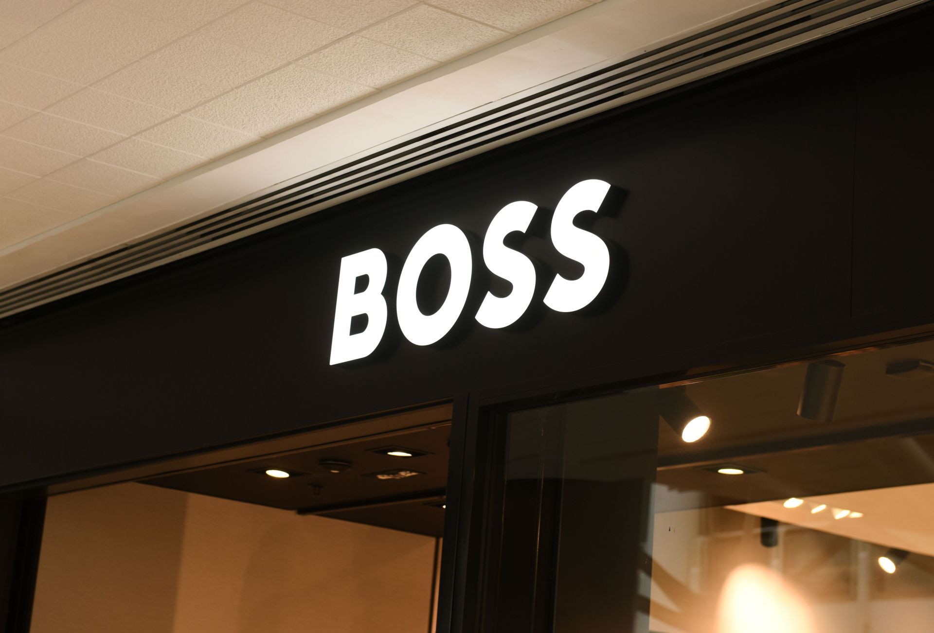 Boss store sign on building exterior, store frontage (Image Via Getty)