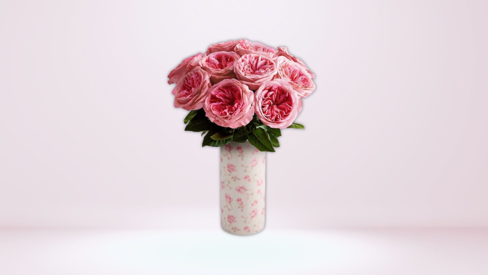 This flower arrangement features a dozen stems of pink garden roses (Image via 1-800-Flowers)