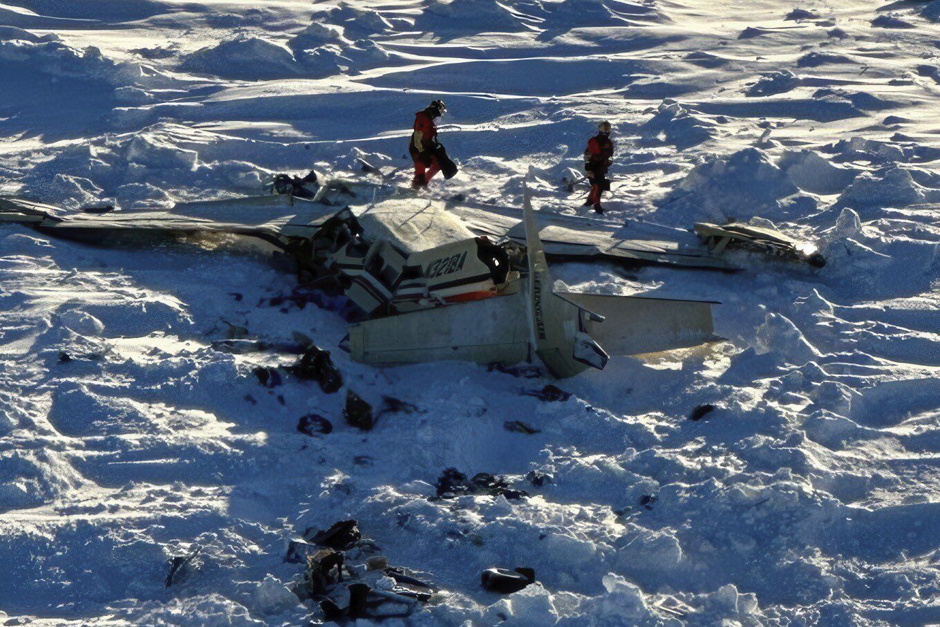 The wreckage of the Bering Air plane crash outside Nome, Alaska, while recovery workers attempt to remove the victims and evaluate the damage in the face of severe winter circumstances. At the isolated crash scene, authorities brave severe weather and shaky ice floes as they continue their investigations. (Image via X/@ohyeslawd)