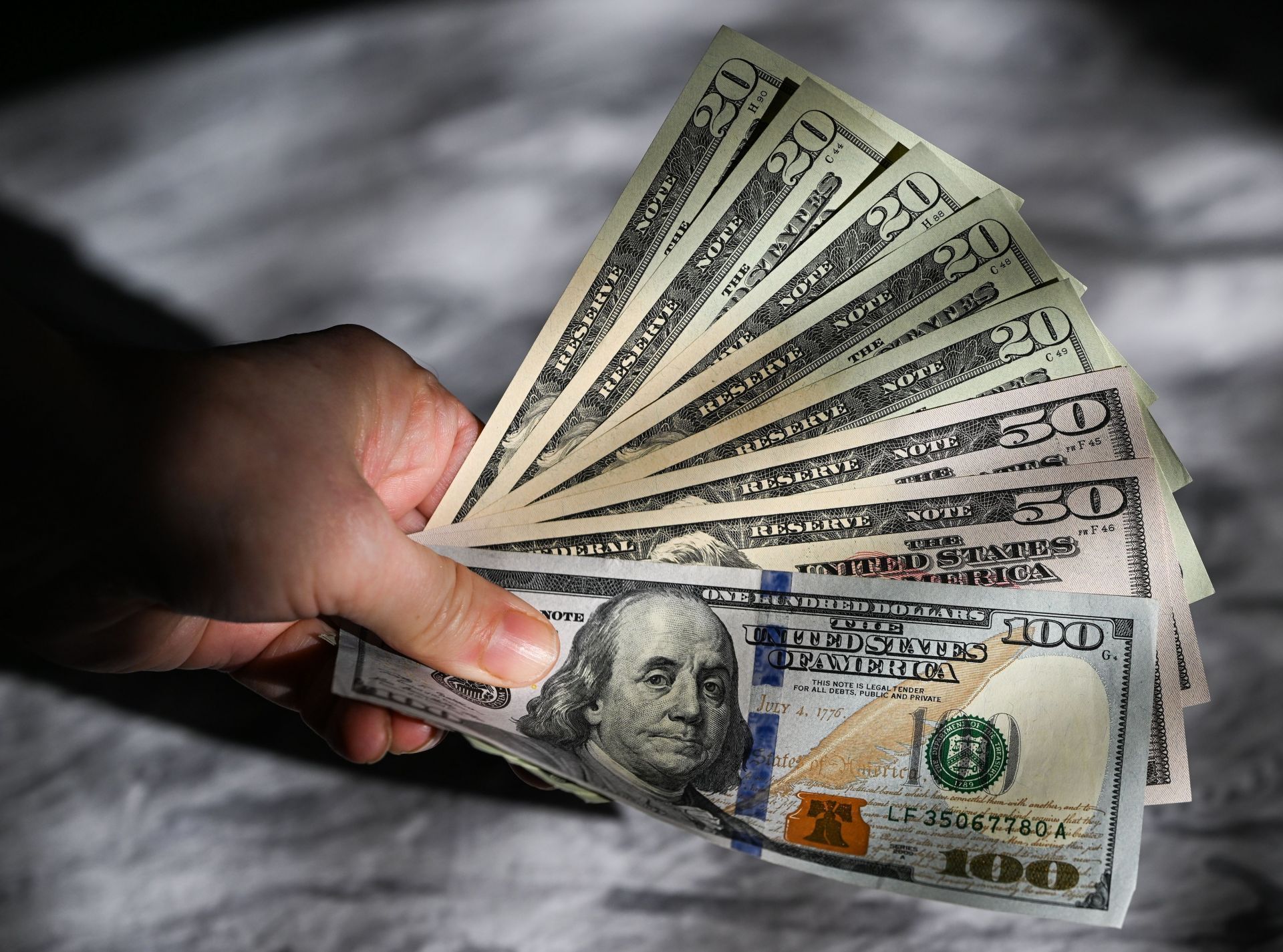 International Currencies In Hand  Financial Illustrations - Source: Getty