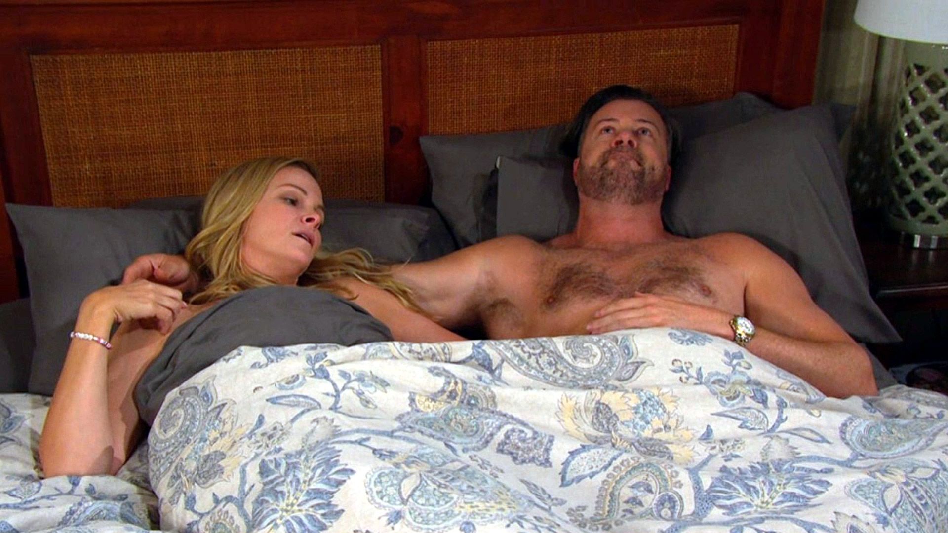 Belle and EJ in bed together. | Image Source: Peacock