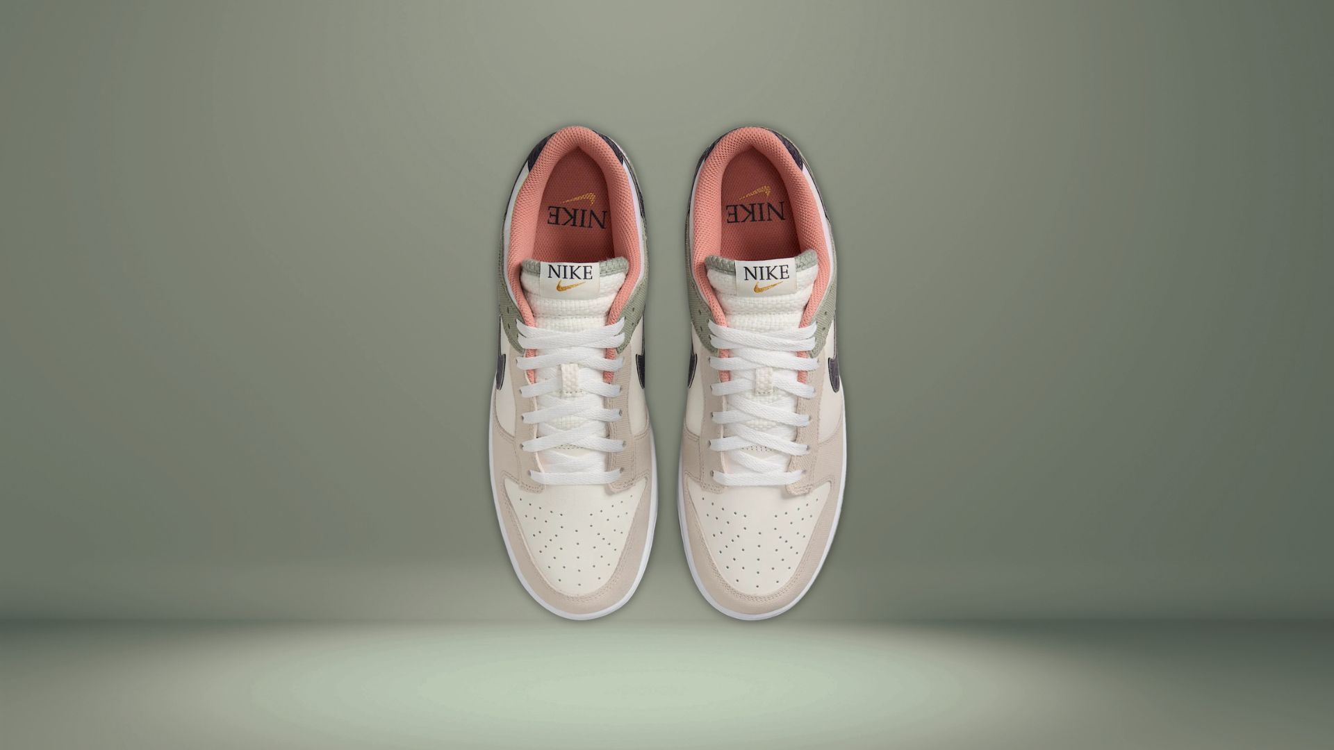 A quick peek into the Nike Dunks SE shoes brings you in contact with a Nike Swoosh embossed on the insoles, surrounded by muted orange color details (Image via Nike)