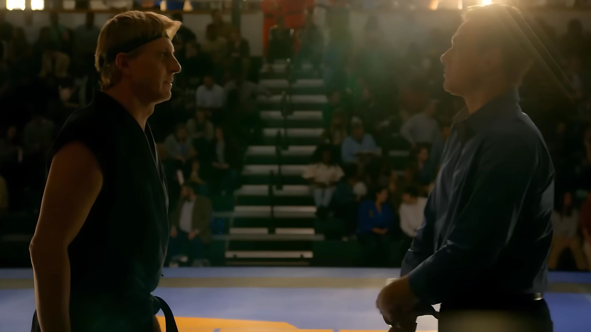 Two men stands facing each other