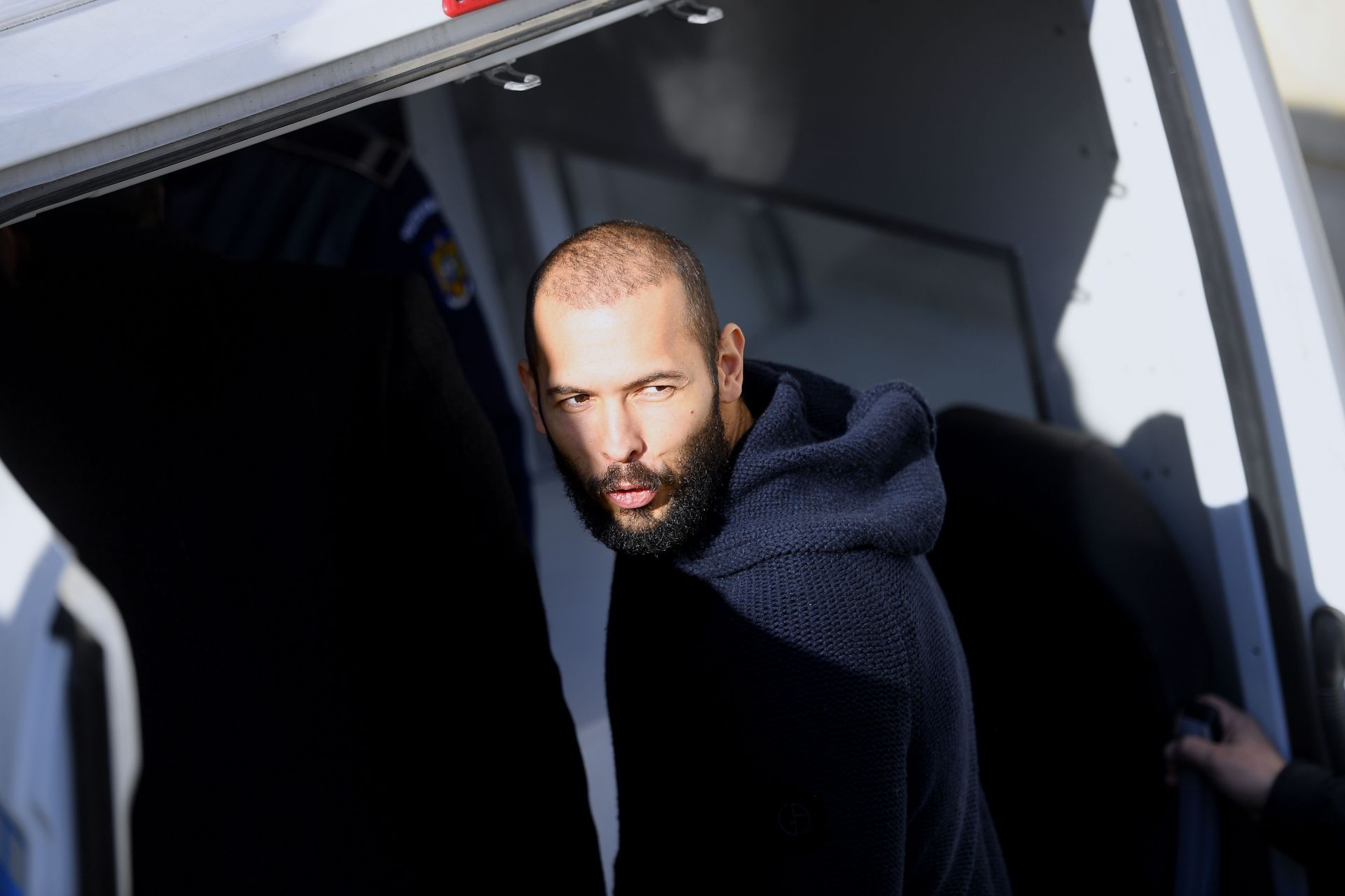 Andrew Tate leaves court after his trial in Romania - Source: Getty