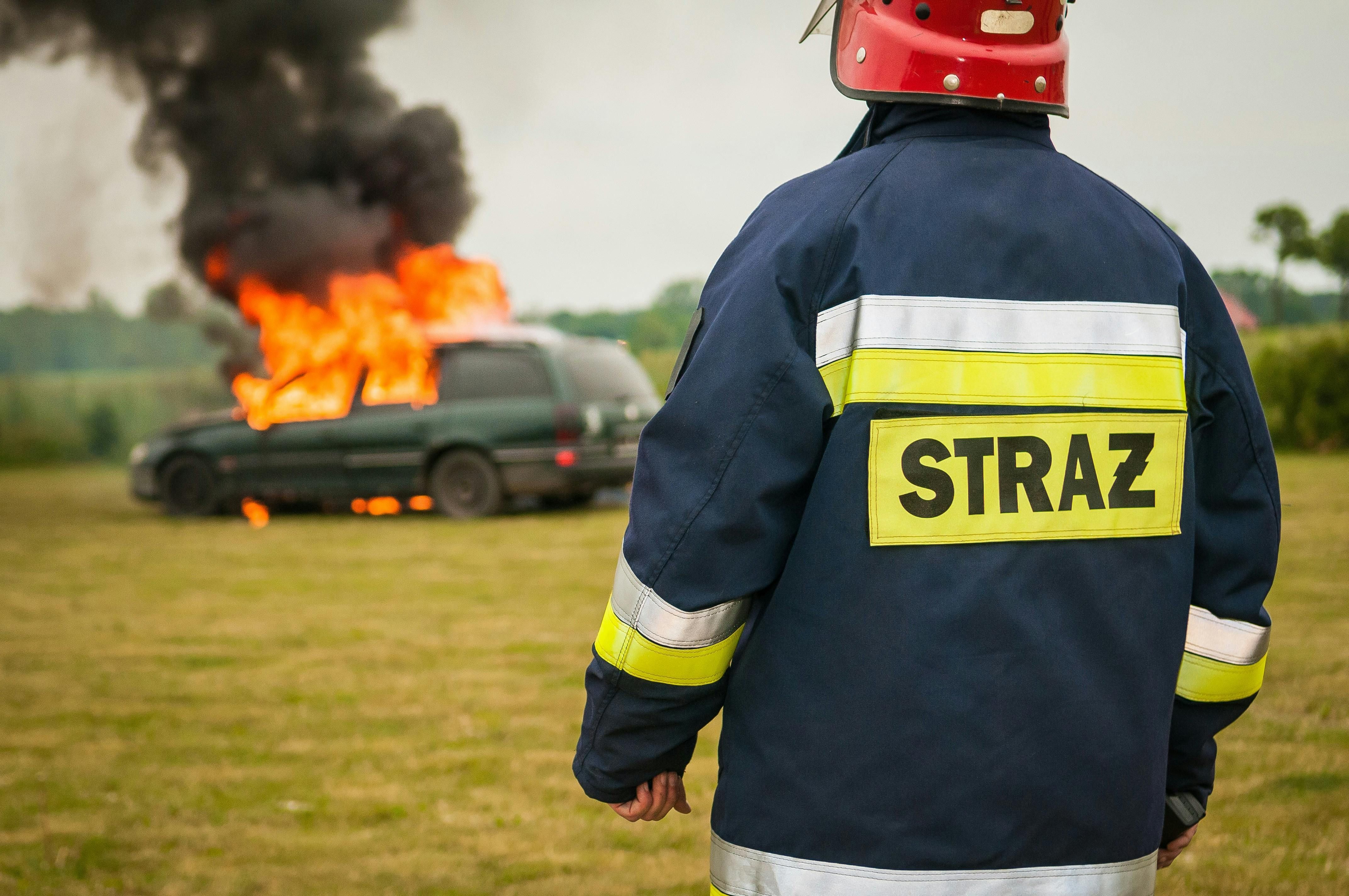 Fireman Watching Flaming Vehicle (Image via Pexels) 