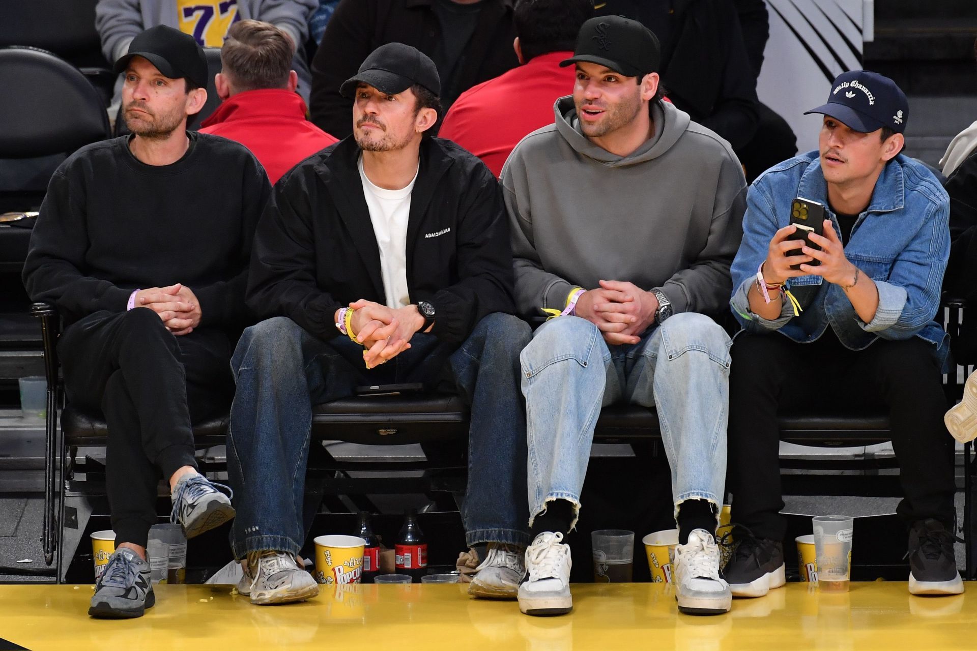 [L-R] Tobey Maguire was captured sitting courtside with Bloom, Fordham and Ramirez(Image via Allen Berezovsky/Getty Images)