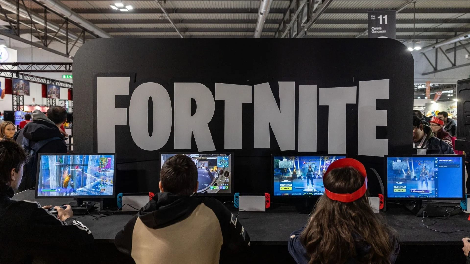 Fairgoers play video games at the Japanese publisher Nintendo Switch